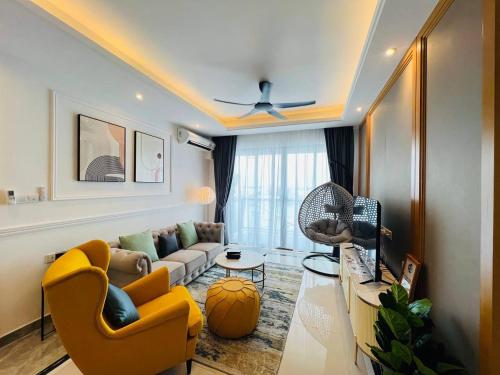 a living room with a couch and a table at R&F PRINCESS COVE at ANJU in Johor Bahru