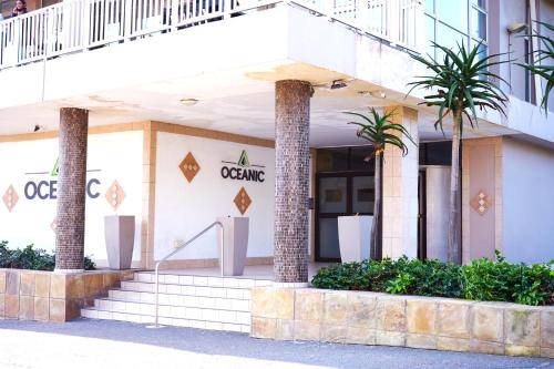 a building with palm trees in front of it at Oceanic eleven in Durban