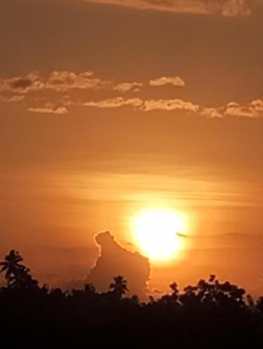 an orange sunset with the sun in the sky at Dishari Tangalle in Tangalle