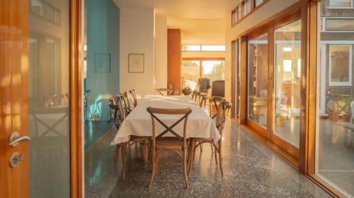 a dining room with a long table and chairs at Seascapes Luxury Retreat in Paraparaumu