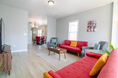 a living room with a red couch and a table at Near NYC Spacious 4 bedroom 2 and a half bath in North Bergen