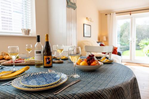 a table with wine glasses and a bowl of fruit at The Summerhouse in Milford on Sea
