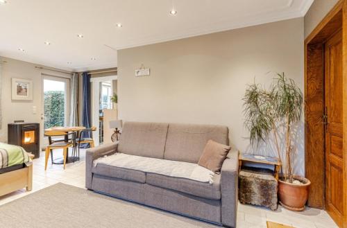 a living room with a couch and a table at Cosy Studio close to Bruxelles South Charleroi Airport in Courcelles