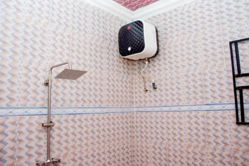 a bathroom with a shower head on the wall at Exclusive Villa 24Hr Solar Electricity in Umuahia