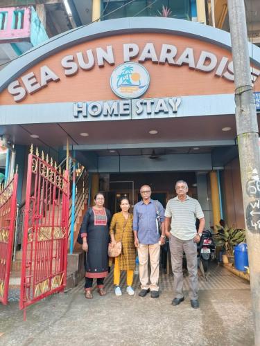 a group of people standing in front of a home stay at SEA SUN PARADISE in Port Blair