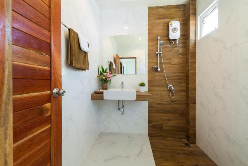 een badkamer met een wastafel en een spiegel bij Phangan Akuna in Srithanu