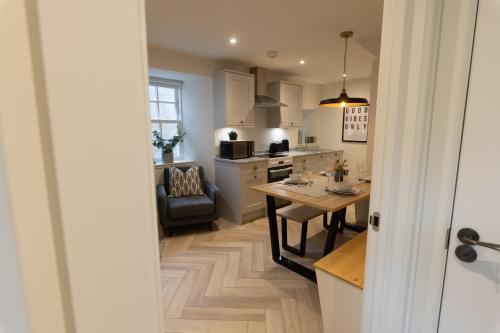 a kitchen with a table and a dining room at Harbourside, Shetland Islands in Lerwick