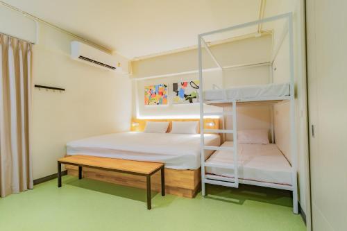 a small room with two bunk beds and a table at Hello my friend in Bang Bua Thong Railway Station