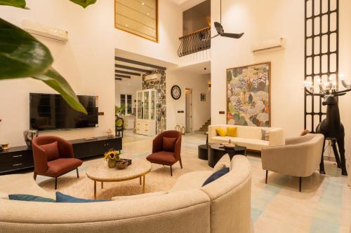 a living room with a couch and chairs at ELIVAAS 4 BHK Villa with Pvt Pool & Jacuzzi-Yashgeet in Siolim