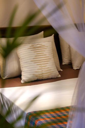 two beds with white pillows on top of them at K O C O O N Villa Madiha in Walgama South