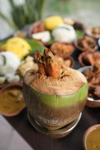 a bowl of food with a crab on top of it at Gram Bangla Retreat in Kolkata