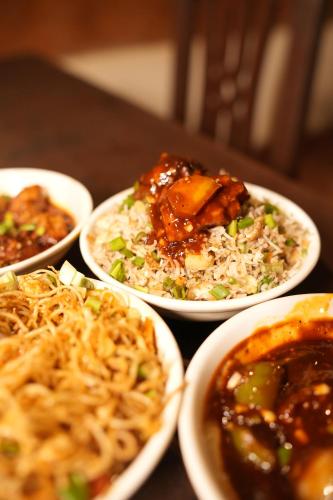 a group of plates of food on a table at Gram Bangla Retreat in Kolkata