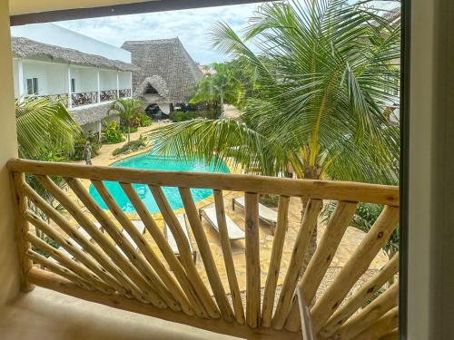 a view of a swimming pool from a balcony at Kibanda Lodge and Beach Club in Nungwi