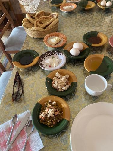 a table with plates of food and eggs on it at Dar Fatma Toujane in Tūjān