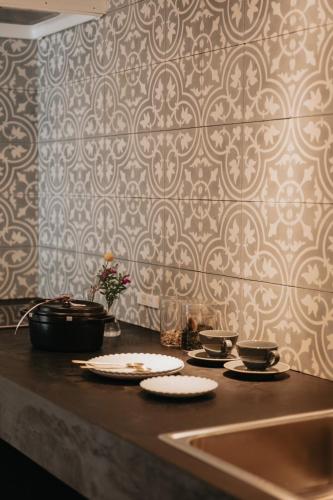 a kitchen with a counter with plates and bowls on it at 貸別荘 山くじら in Kanoya