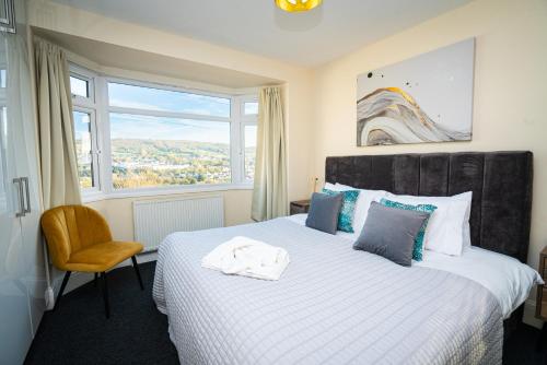 a bedroom with a large bed and a window at Haven in Bath