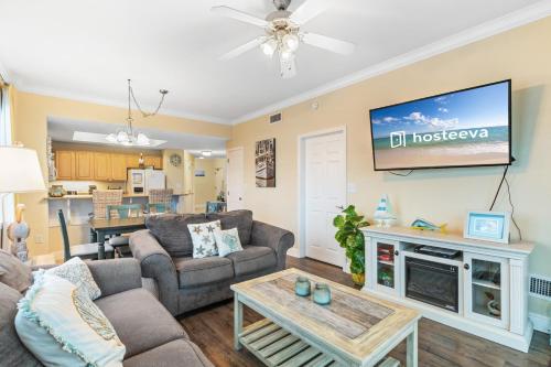 a living room with a couch and a tv at Crystal Tower Condos in Gulf Shores