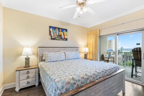 a bedroom with a bed and a balcony at Crystal Tower Condos in Gulf Shores