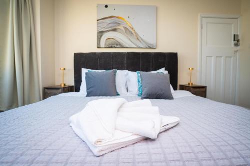a bedroom with a bed with white towels on it at Haven in Bath