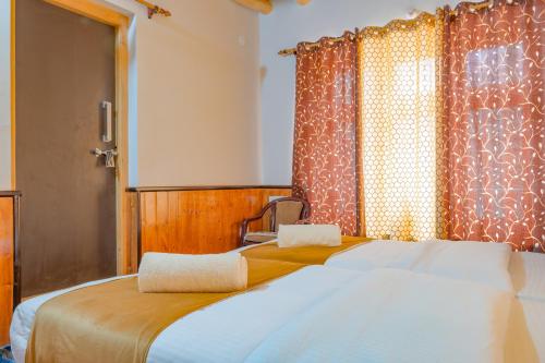 a bedroom with a large bed and a window at Sakti Eco Homestay in Chimre
