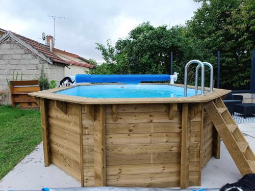 - une piscine avec une terrasse en bois dans l'établissement Charmante petite maison à la campagne, à Soulanges