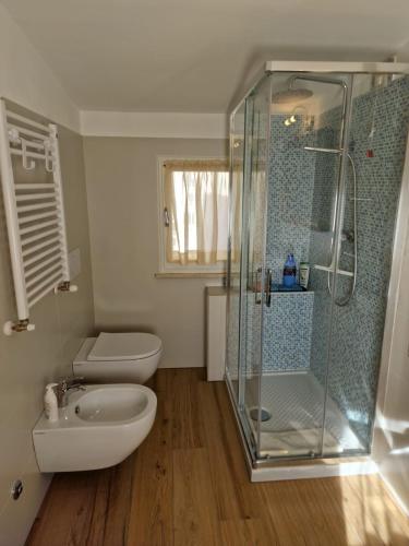 a bathroom with a shower and a toilet and a sink at Casa Myrtifolia in Todi