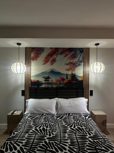 a bedroom with a large bed with a painting on the wall at Hostal Fronton in Alcobendas