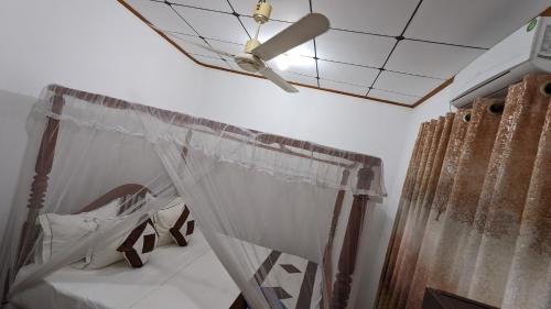 a bedroom with a canopy bed and a ceiling at Hirikatiya Edge in Dickwella