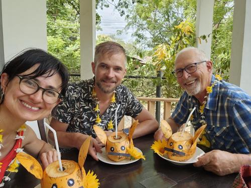 three people sitting at a table with food on plates at Dream Villa Sigiriya in Sigiriya
