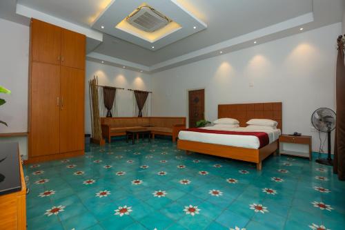 a hotel room with a bed and a desk at Nilan Zingle Resort in Puducherry