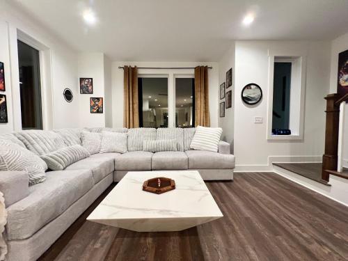 a living room with a couch and a table at New Elevations Rooftop 5 Min to Downtown Nash in Nashville