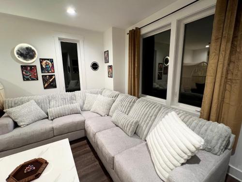 a white couch in a living room with a table at New Elevations Rooftop 5 Min to Downtown Nash in Nashville