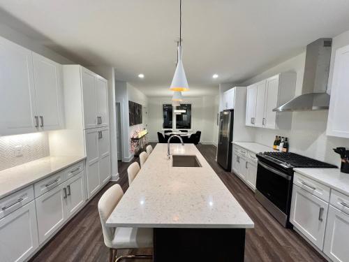 a kitchen with white cabinets and a white counter top at New Elevations Rooftop 5 Min to Downtown Nash in Nashville