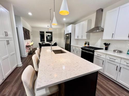 a kitchen with white cabinets and a white counter top at New Elevations Rooftop 5 Min to Downtown Nash in Nashville