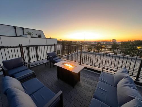 a patio with couches and a table on a balcony at New Elevations Rooftop 5 Min to Downtown Nash in Nashville