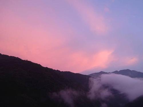 a view of a mountain with clouds in the sky at Oyamanoyado Michitsuji in Otoyocho