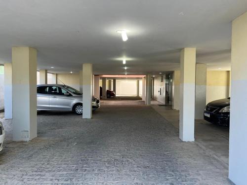 an empty garage with two cars parked in it at ACONCHEGANTE Aptº NA PRAIA DE OLINDA in Olinda