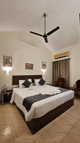 a bedroom with a large bed with a ceiling fan at Holiday Beach Resort in Aguada