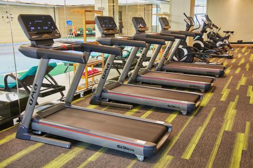 a row of tread machines in a gym at Rising Dragon International Hotel in Dongguan