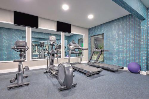 a gym with several tread machines in a room at La Quinta by Wyndham Alvarado in Alvarado