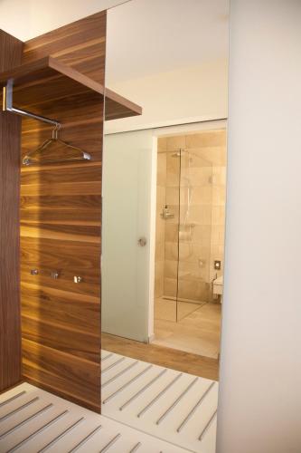 a bathroom with a shower and a glass door at Golfhotel Rheine Mesum in Rheine