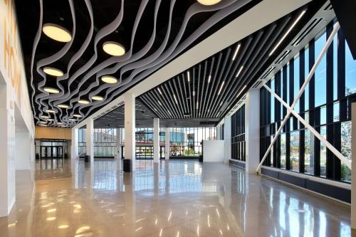 a hallway of a building with a ceiling with lights at Doubletree By Hilton Battle Creek in Battle Creek