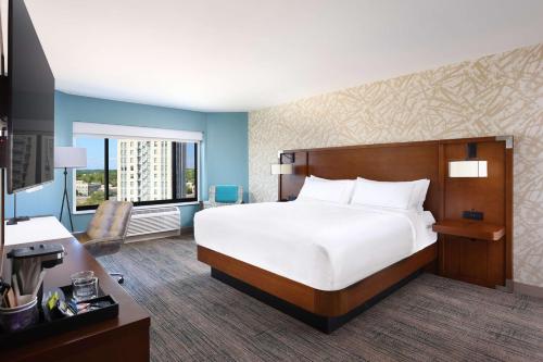 a hotel room with a bed and a desk at Doubletree By Hilton Battle Creek in Battle Creek