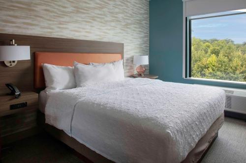 a bedroom with a large bed and a window at Home2 Suites By Hilton Lynchburg in Lynchburg