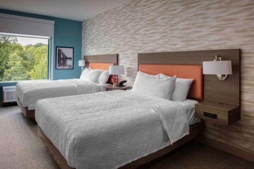 a hotel room with two beds and a window at Home2 Suites By Hilton Lynchburg in Lynchburg