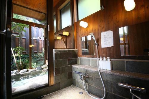 a bathroom with a shower in a building at Hotel Soyokaze in Hakuba