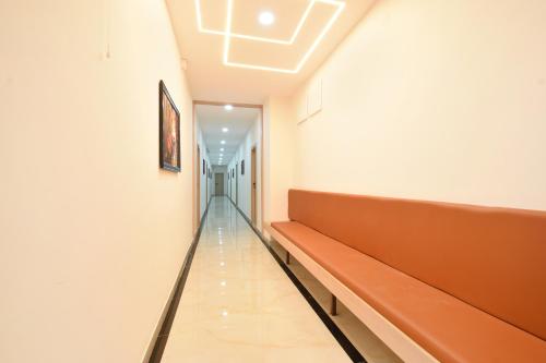 a hallway with a bench in a hospital at FabHotel Narsingi - Nr Global Eye Hospital, Narsingi in Hyderabad