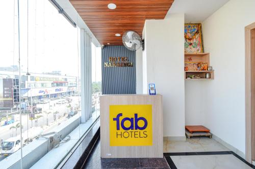 a frito lay hotel lobby with a sign on the wall at FabHotel Narsingi - Nr Global Eye Hospital, Narsingi in Hyderabad