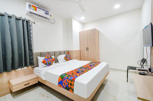 a bedroom with a bed and a television in it at FabHotel Narsingi - Nr Global Eye Hospital, Narsingi in Hyderabad