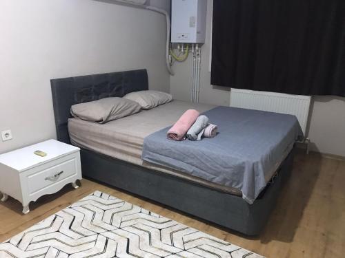a bedroom with a bed with two pillows on it at meva pansiyon in Küçük Çığlı